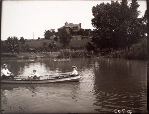 Solomon D. Butcher, Boating on the irrigation canal in front of the C. B. Reynolds house, Kearney, Buffalo County, Nebraska, 1904, black & white photograph (from glass plate negative in the Nebraska State Historical Society Collection), c. 1982-1984