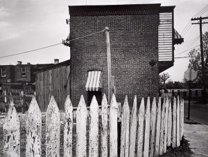 Wright Morris, Picket Fence and Building, Near Chester, Pennsylvania, 1940, silver print, 1975