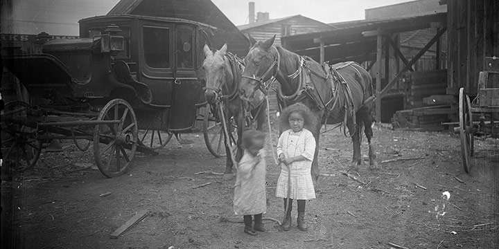 John Johnson, Untitled (children and horses by stable), black & white photograph (from glass plate negative in the MONA Archives Collection), 2018, 11 × 16½"